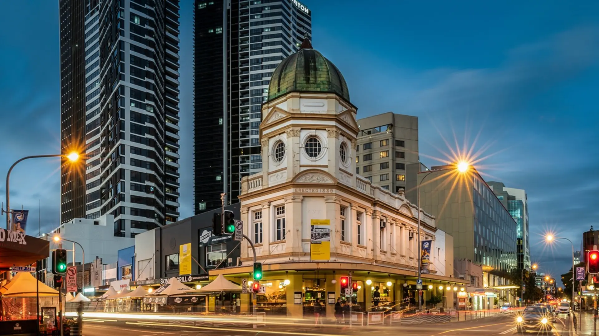Historic Parramatta CBD streetscape with the heritage domed corner building and modern towers, a service area where Mould Hunters treats mould in apartments, homes and commercial buildings